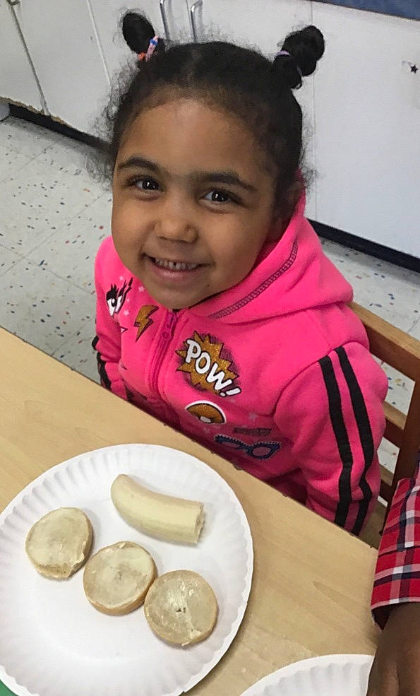 Maleigha is registered to the contest to win money with this photo: baking, chair, child, comfort_food, cooking, cuisine, dish, event, finger_food, food, happy, ingredient, joy, junk_food, person, plate, smile, spoon, sweetness, table