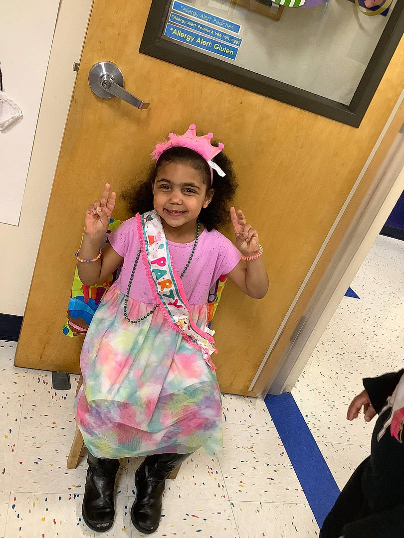 Maleigha is registered to the contest to win money with this photo: baby_toddler_clothing, child, event, eyewear, fashion_design, flooring, fun, happy, joy, magenta, pattern, person, picture_frame, pink, purple, room, sandal, sleeve, smile, textile