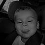 boy, car_seat, casual_clothing, child, childhood, closeup, cute, face, fun, happy, head_and_shoulders, indoors, playful, portrait, seat, seatbelt, smile, tongue_out, vehicle_interior, young_child