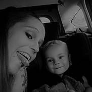 Alexys a rejoint le concours — aidez-le/la à gagner de superbes lots ! black_and_white, blanket, candid, car_interior, child, child_seat, face, family, happy, head, person, piercing, playful, portrait, seat, seatbelt, smile, tattoo, toddler, woman
