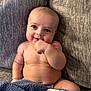Amias is registered to the contest to win money with this photo: baby, child, smiling, blue_blanket, couch, cushion, indoors, happy, skin, face, hand, diaper, plush, comfortable, infant, cute, portrait, sitting, young, cozy