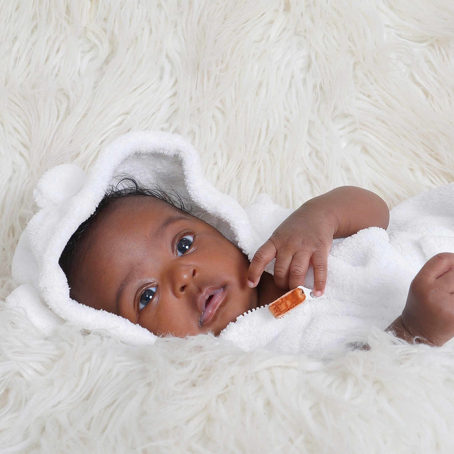 Milah joined the competition — help win amazing prizes! baby, child, close_up, cozy, cute, expression, eyes, face, fur, hand, hooded_towel, indoors, infant, laying_down, newborn, portrait, skin, sleepwear, soft_texture, white_towel