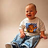 baby, child, smiling, sitting, tshirt, jeans, sneakers, cute, happy, portrait, studio, casual, fashion, footwear, infant, one_person, indoor, young_child, clothing, playful