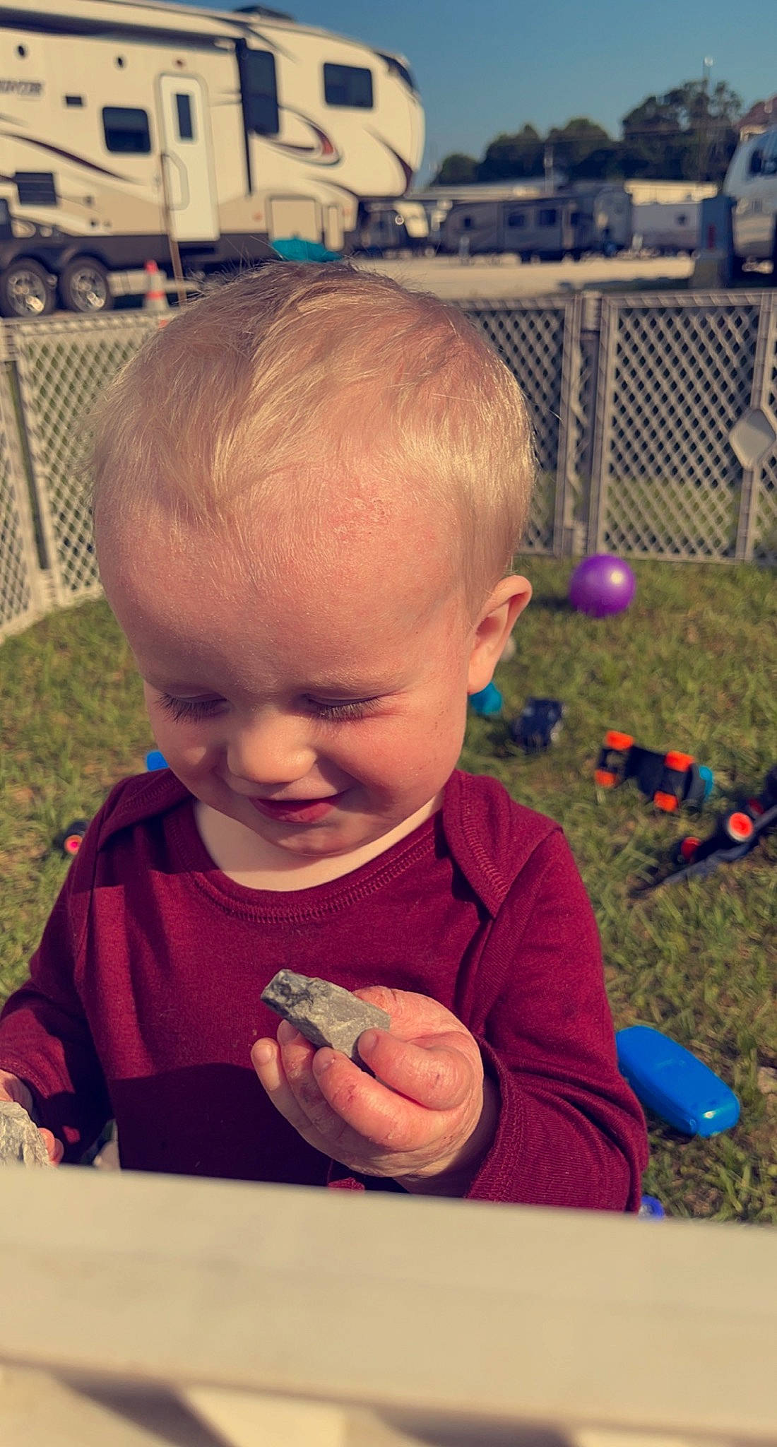 Michael is registered to the contest to win money with this photo: baby, baby_playing_with_toys, baby_toddler_clothing, cheek, child, finger, fun, grass, hairstyle, happy, joy, mouth, nose, people, person, photograph, skin, smile, snapshot, thumb