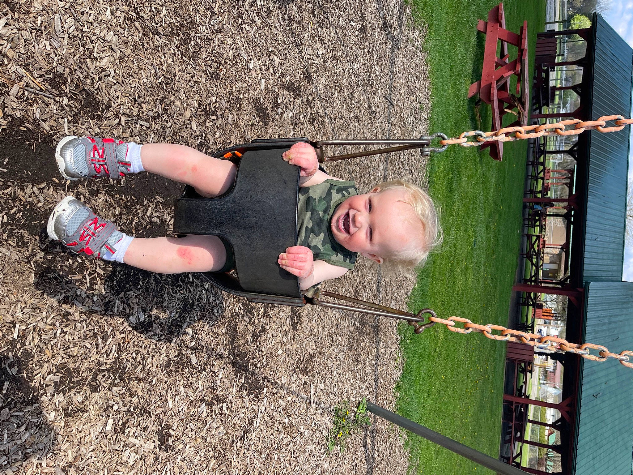 Michael is registered to the contest to win money with this photo: asphalt, child, fun, grass, human_body, human_leg, knee, leisure, people_in_nature, person, recreation, shadow, sock, soil, thigh, toddler, tree, walking_shoe