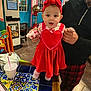 Lietys joined the competition — help win amazing prizes! baby, child, red_dress, headband, table, colorful_tiles, adult_hand, restaurant, gumball_machine, cup_with_straw, floor, chair, plaid_pants, person, indoor, holding_hands, pink_shoes, cute, smiling, decor