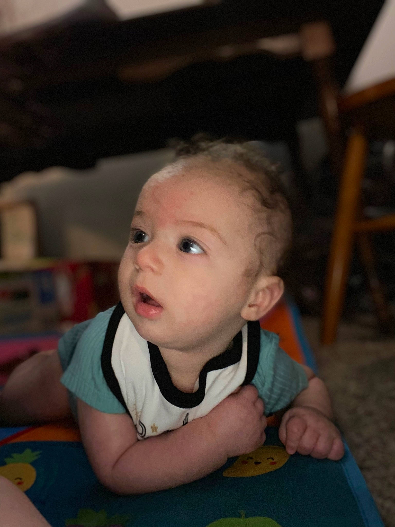 Eli is registered to the contest to win money with this photo: baby, baby_toddler_clothing, chair, cheek, child, chin, comfort, flooring, fun, happy, iris, mouth, nose, person, room, sitting, skin, smile, t_shirt, toddler