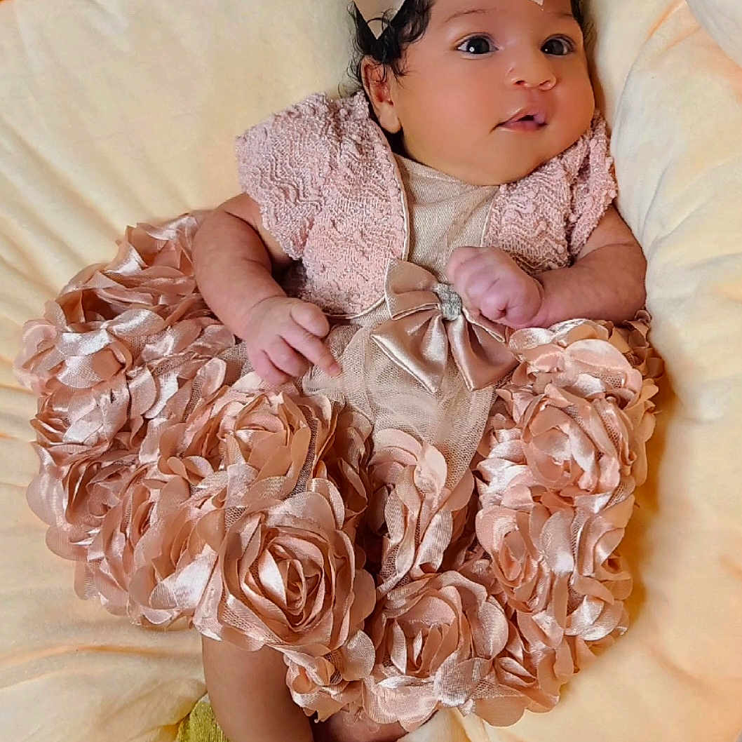 Symphony H. joined the competition — help win amazing prizes! adorable, baby, bow, child, cozy, cushion, cute, dress, flower, happy, indoors, infant, newborn, portrait, satin, skin, sleeping_area, small_hands, socks, soft