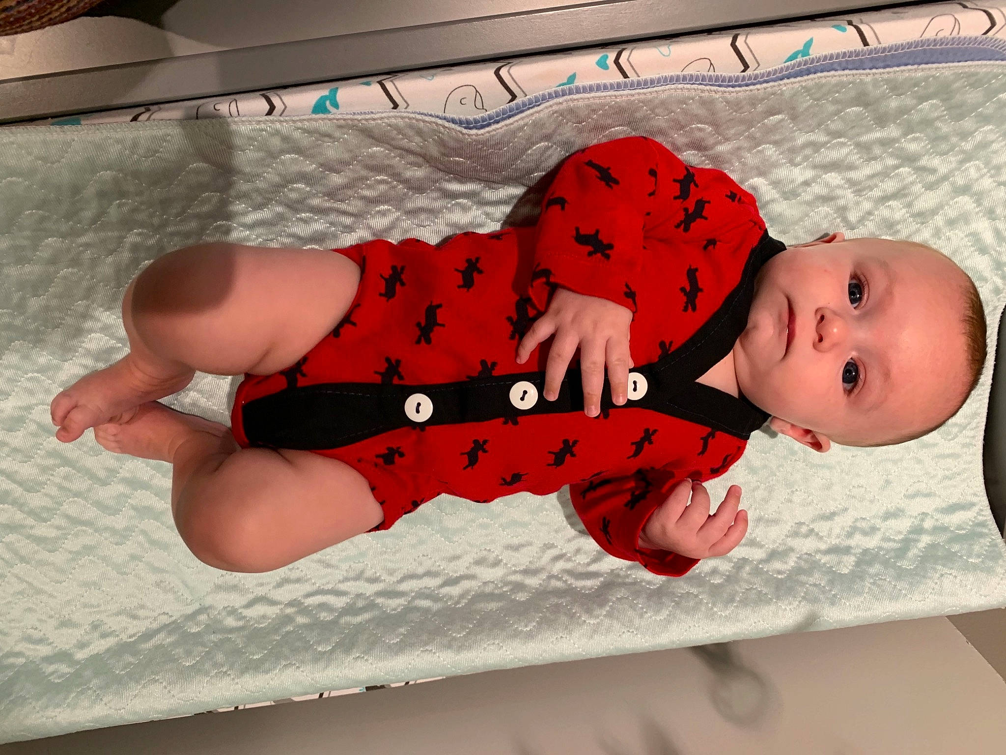 Alaric is registered to the contest to win money with this photo: baby, baby_products, baby_safety, baby_sleeping, baby_toddler_clothing, carmine, comfort, elbow, finger, flooring, happy, headgear, human_body, human_leg, linens, pattern, person, sleeve, textile, thigh