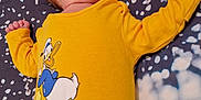 Christopher joined the competition — help win amazing prizes! baby, sleeping, yellow_onesie, donald_duck, cartoon, infant, child, blanket, pattern, bed, clothing, cute, peaceful, lying_down, portrait, soft_lighting, indoors, head, face, small_hands