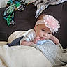 baby, infant, headband, flower, blanket, couch, furniture, soft, cozy, child, indoors, resting, lying_down, clothing, cute, portrait, skin, person, young_child, blanket_folded