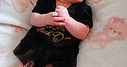 Kinsley is registered to the contest to win money with this photo: baby, baby_girl, black_outfit, blanket, child, clothing, cute, happy, indoors, infant, lying_down, newborn, person, portrait, skin, small_hands, smiling, soft_texture, teddy_bear_pattern, tulle_skirt