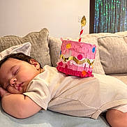 Karalena is registered to the contest to win money with this photo: baby, sleeping, birthday, party_hat, cupcake, couch, sofa, blanket, portrait, face, child, indoors, home, celebration, pink, colorful, candles, relaxed, nap, photography
