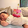 baby, sleeping, birthday, party_hat, cupcake, couch, sofa, blanket, portrait, face, child, indoors, home, celebration, pink, colorful, candles, relaxed, nap, photography