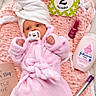 Kori joined the competition — help win amazing prizes! baby, infant, two_months, portrait, lying_down, pink, blanket, robe, turban, pacifier, smiling, face, eyes, indoor, milestone_card, cosmetics, lotion, lipstick, soft_texture, baby_photoshoot