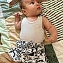 Milo participe au concours pour gagner de l'argent avec cette photo : baby, infant, child, lying_down, quilt, blanket, tank_top, patterned_shorts, blue_eyes, skin, arm, leg, cute, soft_texture, indoor, closeup, portrait, clothing, baby_garment, curious
