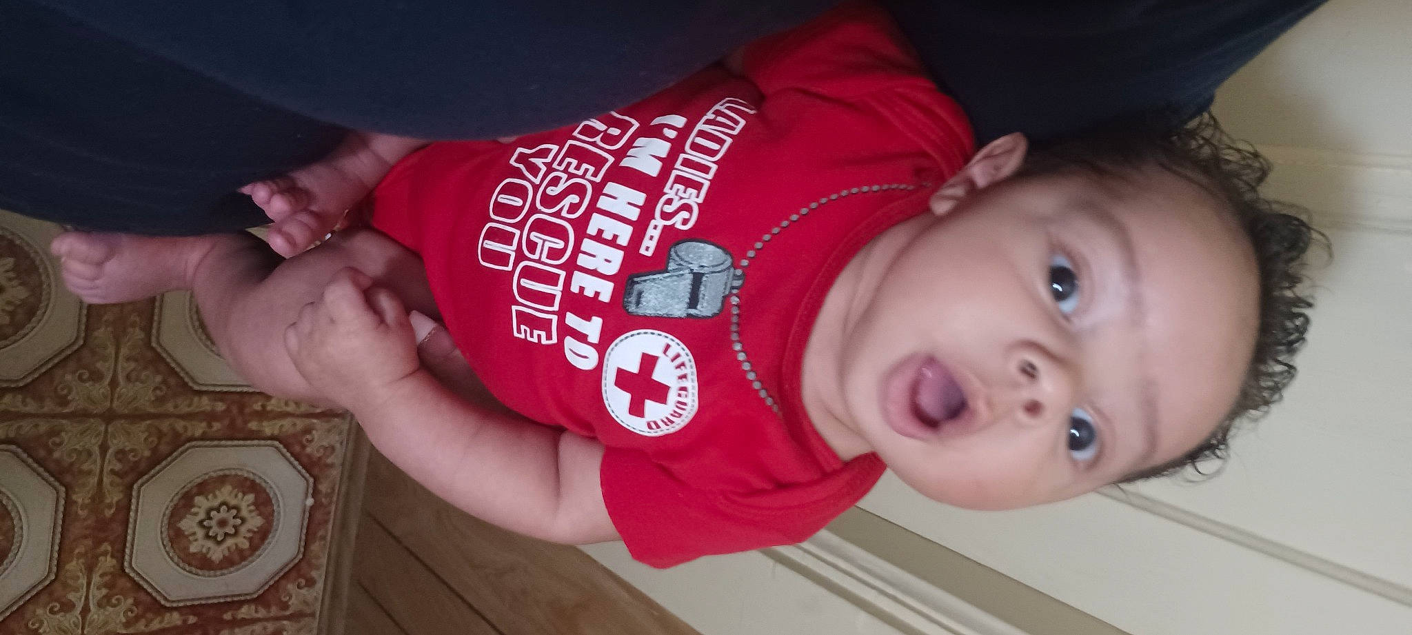 Trae'Jon is registered to the contest to win money with this photo: arm, baby, baby_toddler_clothing, carmine, cheek, child, elbow, finger, fun, lip, mouth, nail, nose, organ, person, skin, sleeve, t_shirt, thumb, toddler