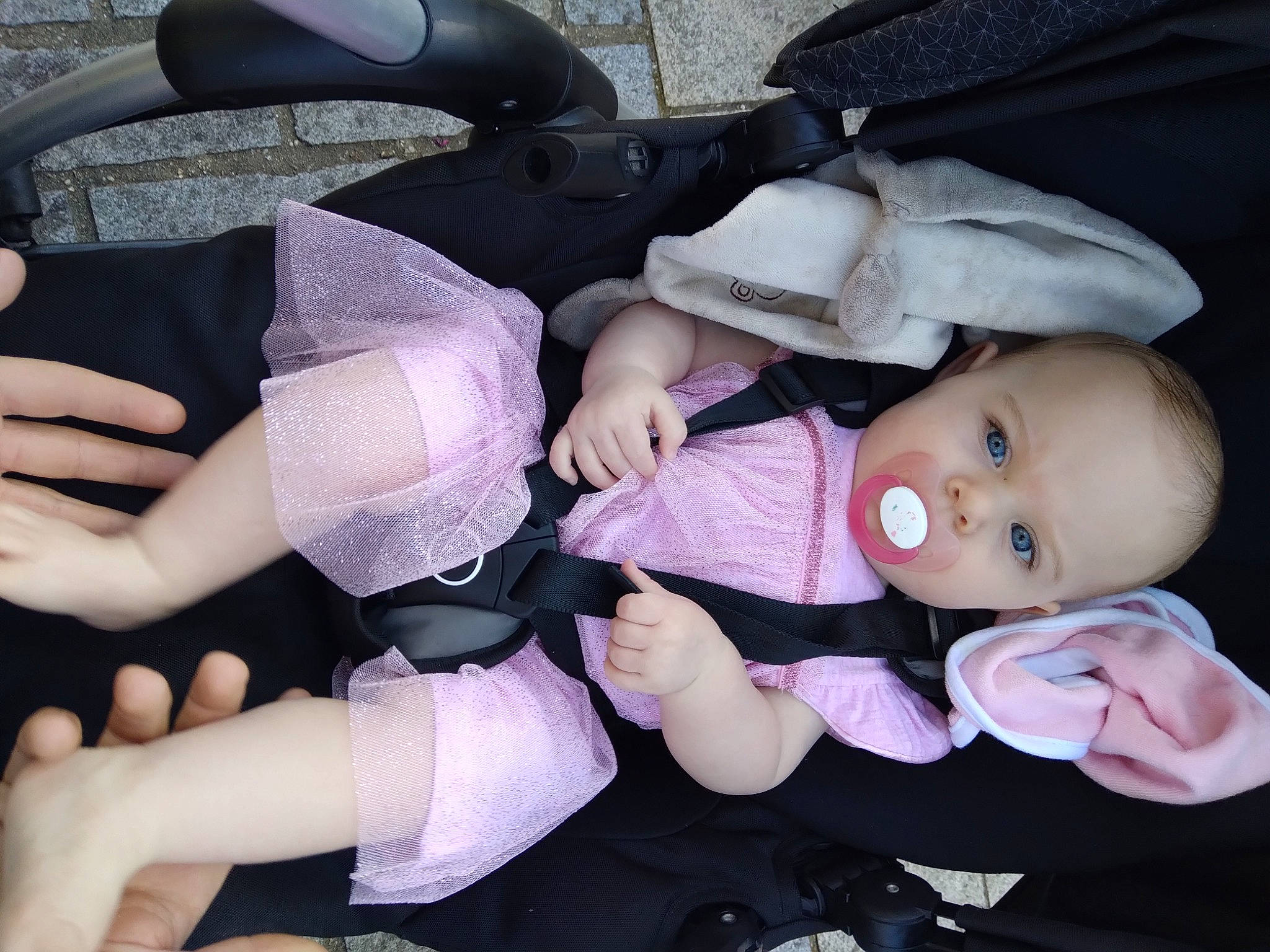 Elina a rejoint le concours — aidez-le/la à gagner de superbes lots ! baby, baby_carriage, baby_products, baby_toddler_clothing, car_seat, cheek, child, comfort, fashion_accessory, finger, gesture, hand, lap, nail, person, pink, skin, thigh, thumb, toddler