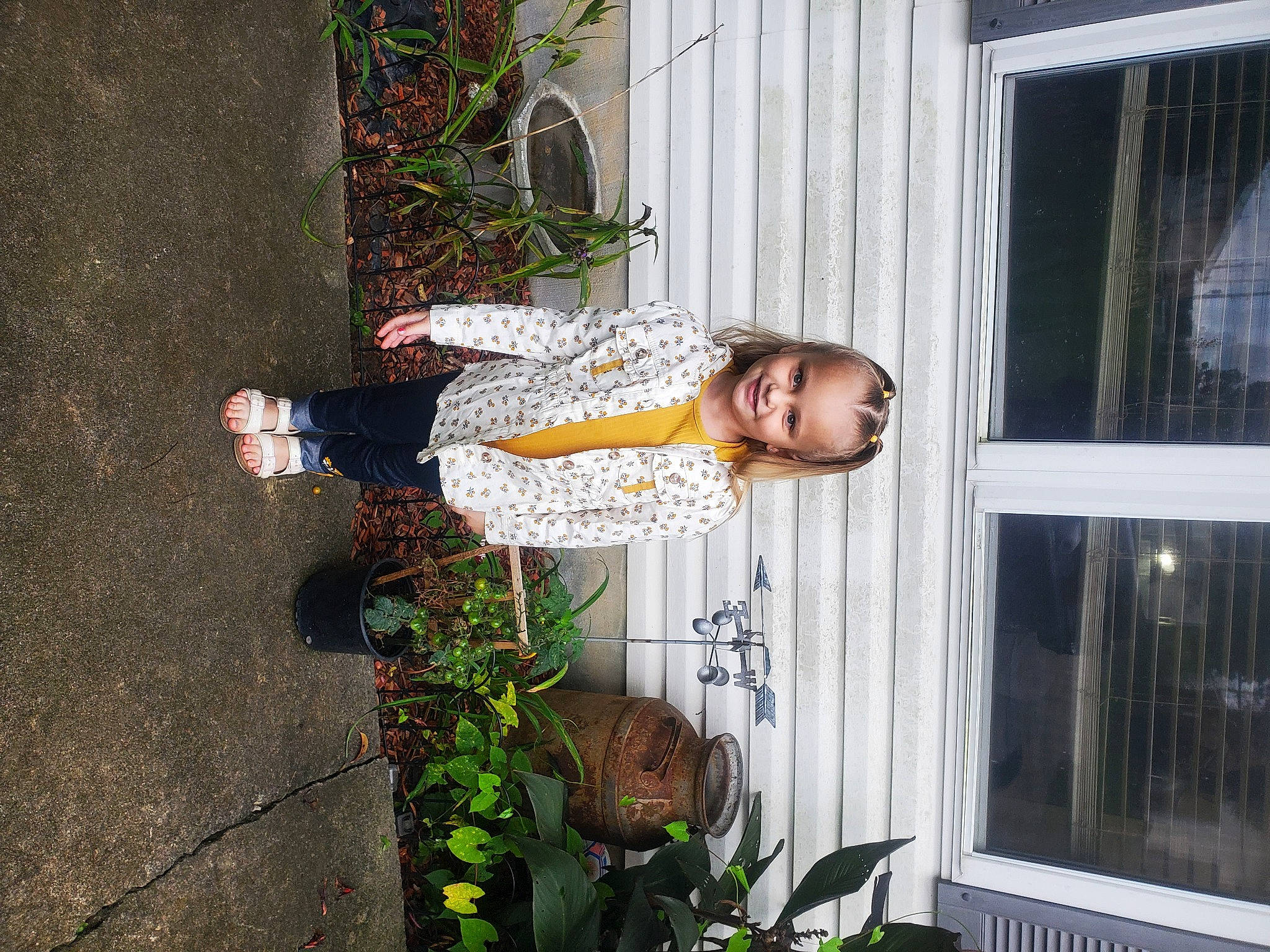 Delaney is registered to the contest to win money with this photo: building, child, flower, flowerpot, glass, home_door, houseplant, joy, leaf, person, plant, smile, toddler, window, wood