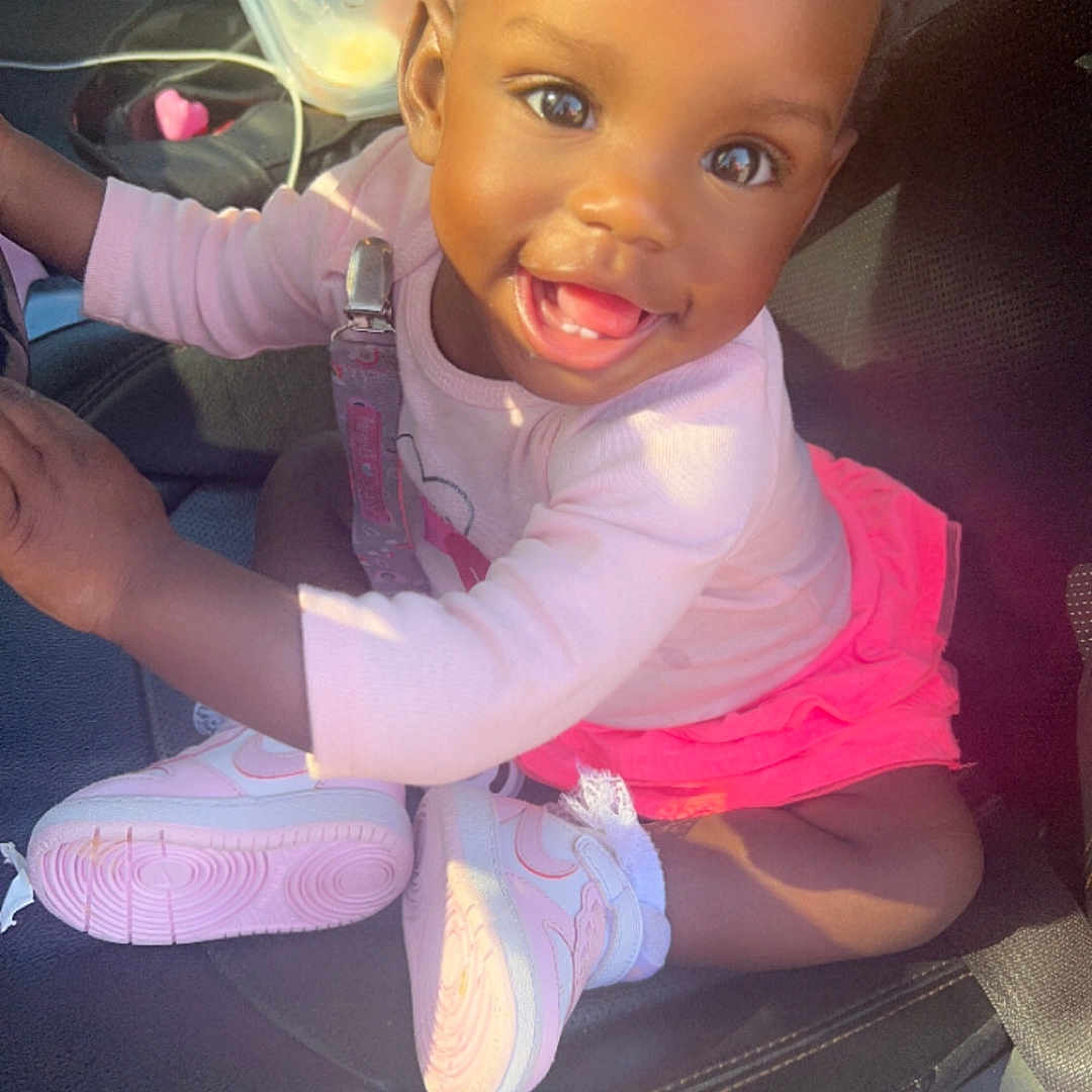 Jaysha is registered to the contest to win money with this photo: accessories, baby, bodypart, car, clothing, cushion, face, footwear, glove, happy, head, homedecor, mouth, person, photography, portrait, shoe, sitting, sneaker, teeth