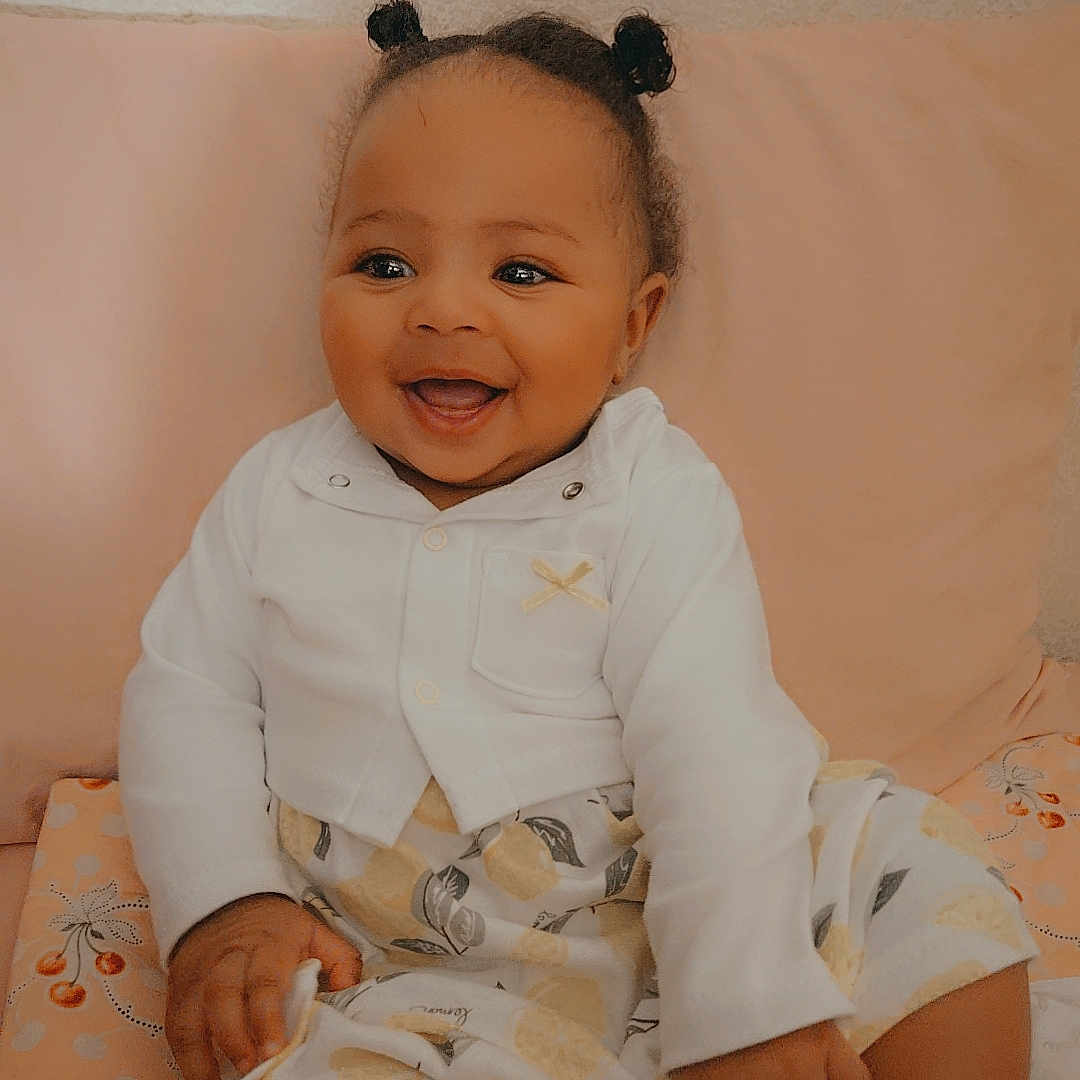 Lovelybillie is registered to the contest to win money with this photo: baby, babylaughing, bodypart, clothing, couch, cushion, dress, face, finger, furniture, hand, happy, head, homedecor, newborn, person, photography, portrait, sitting, smile