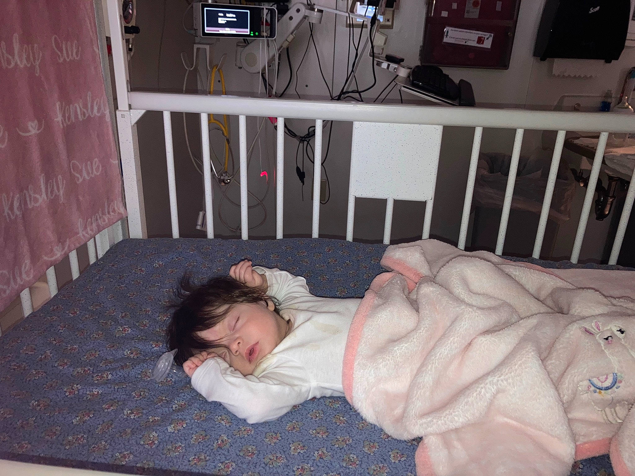 Kensley is registered to the contest to win money with this photo: baby_products, bed_sheet, bedding, bedroom, child, comfort, door, fence, flooring, fun, hardwood, house, knee, linens, nap, person, room, sitting, sleep, white