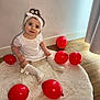 baby, child, girl, white_dress, headband, red_balloons, sitting, rug, wooden_floor, curtains, indoor, smiling, looking_up, cute, happy, decor, soft_light, portrait, floor, cozy