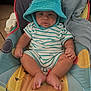 baby, infant, child, hat, bucket_hat, teal, striped_onesie, baby_seat, colorful, indoor, cute, chubby_cheeks, pout, fabric, soft, comfort, person, young_child, sitting, portrait