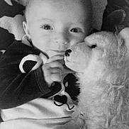 Hadès a rejoint le concours — aidez-le/la à gagner de superbes lots ! baby, infant, stuffed_animal, plush_toy, cuddle, blanket, face, eyes, hand, cozy, monochrome, black_and_white, soft_texture, portrait, child, smiling, cute, indoor, comfort, young