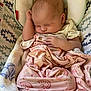 baby, newborn, sleeping, blanket, pink, heart_pattern, rainbow_pattern, baby_seat, cushion, zigzag_pattern, infant, soft, cozy, cute, peaceful, child, resting, clothing, indoors, portrait