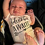 baby, infant, onesie, car_seat, smile, happy, face, feet, arms, clothing, child, person, cute, newborn, skin, sitting, closeup, indoor, expression, resting