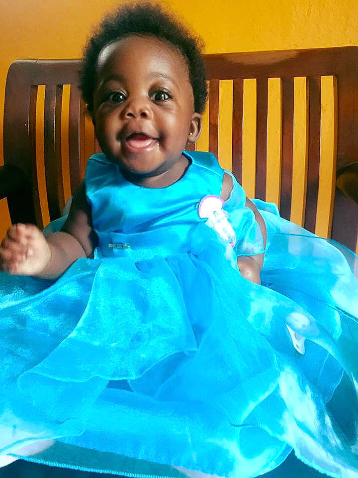 Maliah joined the competition — help win amazing prizes! beauty, blue, child, day, eye, face, facial_expression, fun, girl, head, human, infant, outerwear, person, sitting, skin, smile, textile, toddler, turquoise