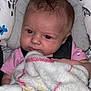 Sophia joined the competition — help win amazing prizes! baby, infant, blanket, car_seat, cushion, face, red_eye, clothing, pink_shirt, hair, child, person, soft_texture, pattern, indoor, close_up, expression, bundle, comfort, seatbelt