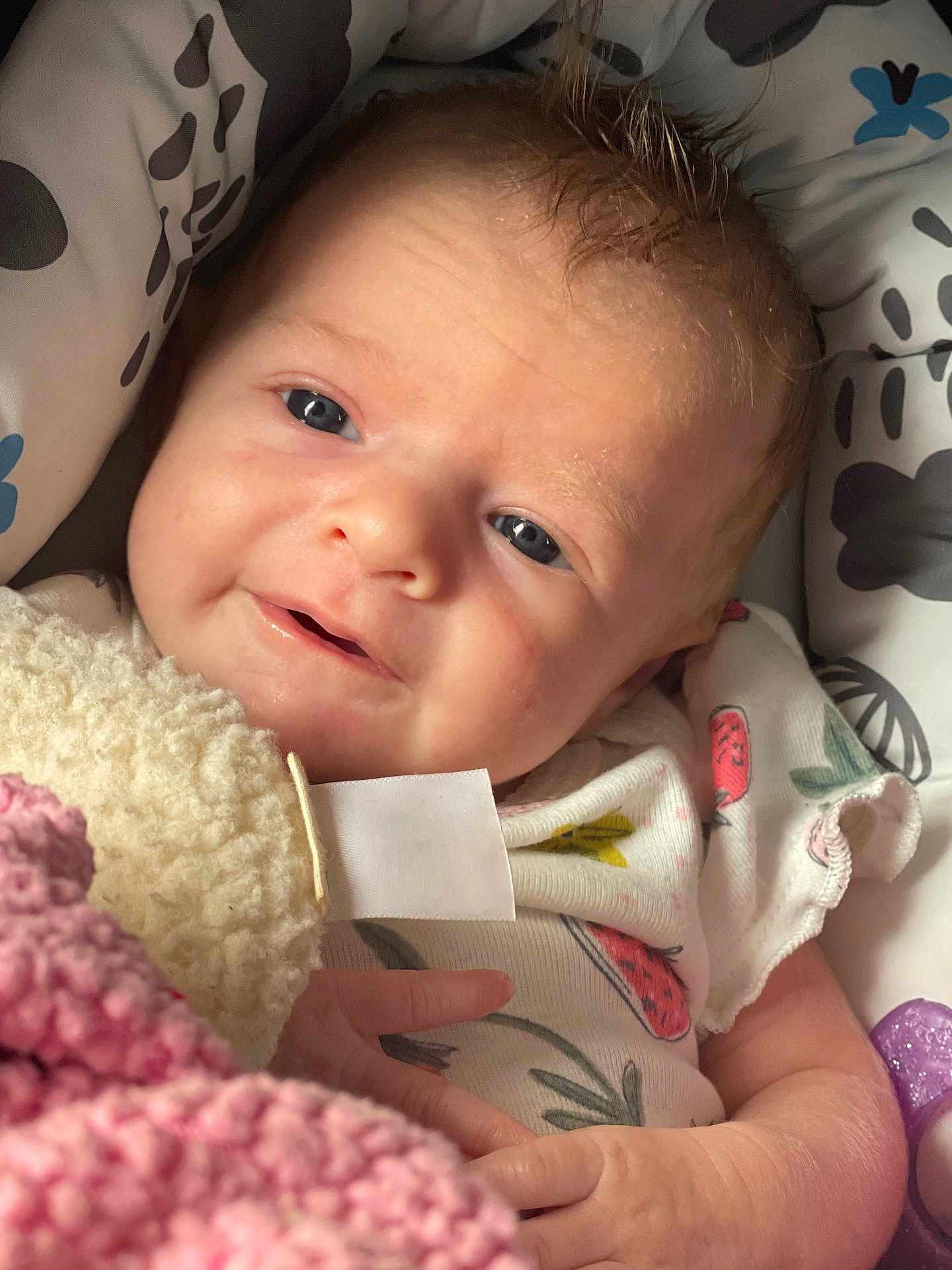 Sophia is registered to the contest to win money with this photo: baby, infant, smiling, close_up, blanket, onesie, cute, face, child, newborn, soft_texture, cozy, hand, lying_down, indoor, skin, expression, portrait, young, cute_face