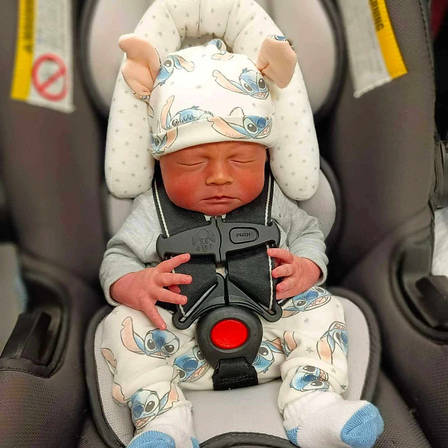 River joined the competition — help win amazing prizes! baby, newborn, car_seat, infant, sleeping, child, hat, clothing, straps, socks, cute, face, small_hands, seatbelt, child_seat, transport, indoors, resting, adorable, cartoon_print