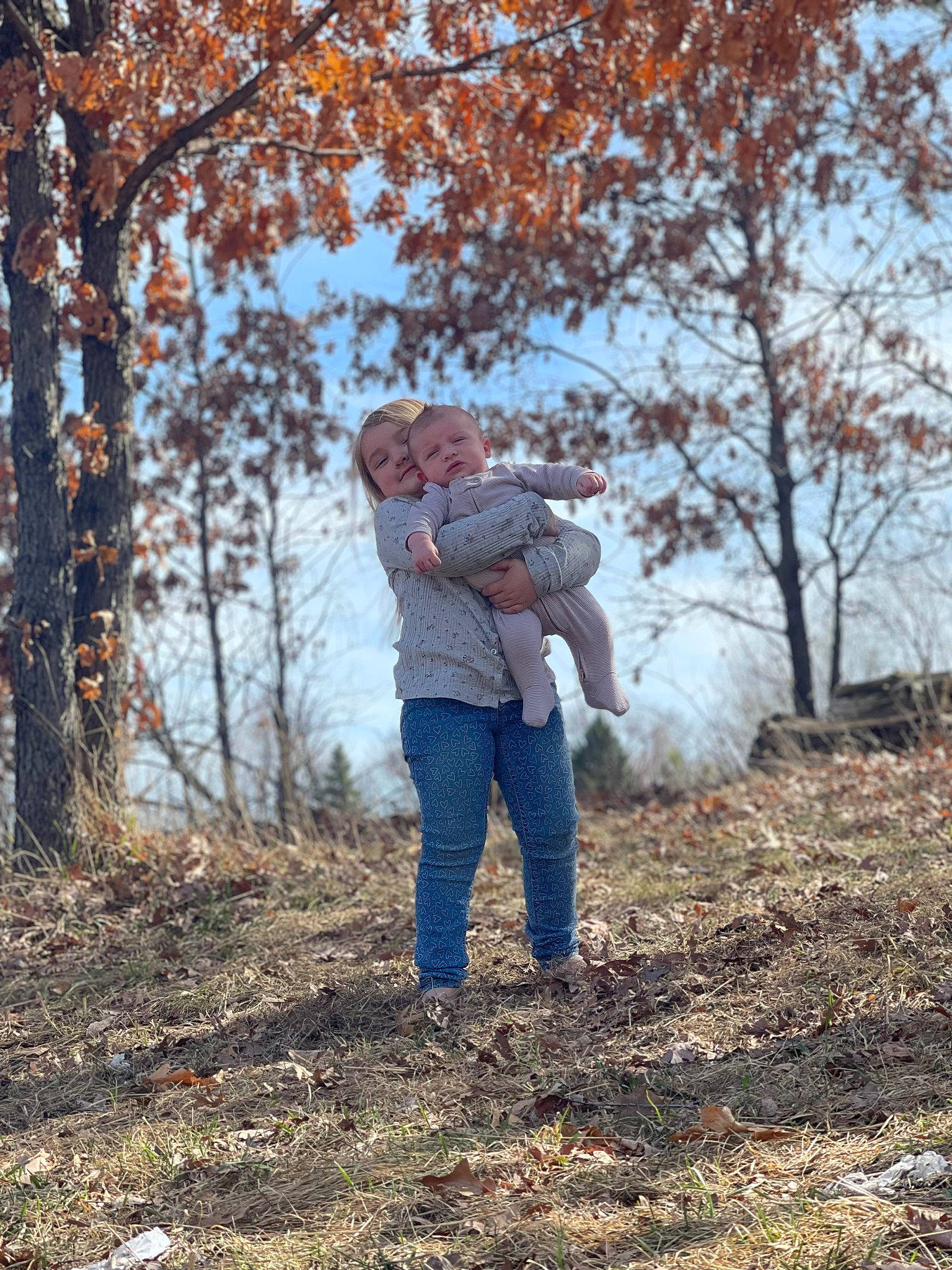 Leelind is registered to the contest to win money with this photo: branch, deciduous, forest, fun, gesture, grass, happy, jeans, landscape, natural_landscape, people_in_nature, person, plant, recreation, sky, soil, sorrow, tree, trunk, twig