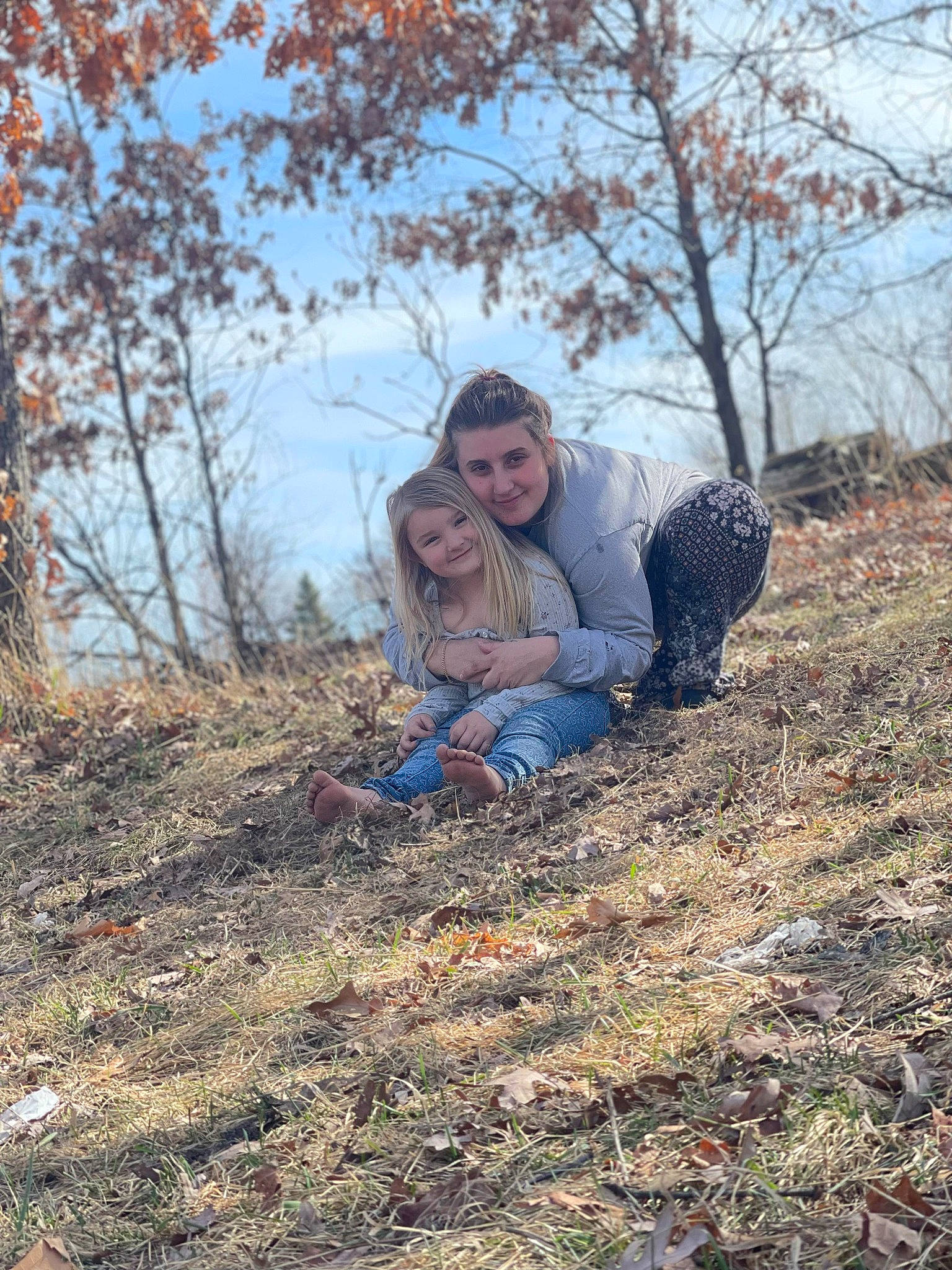 Brooklyn joined the competition — help win amazing prizes! branch, deciduous, electric_blue, fawn, forest, grass, happy, joy, landscape, natural_landscape, people_in_nature, person, plant, sitting, sky, smile, soil, tree, twig, winter