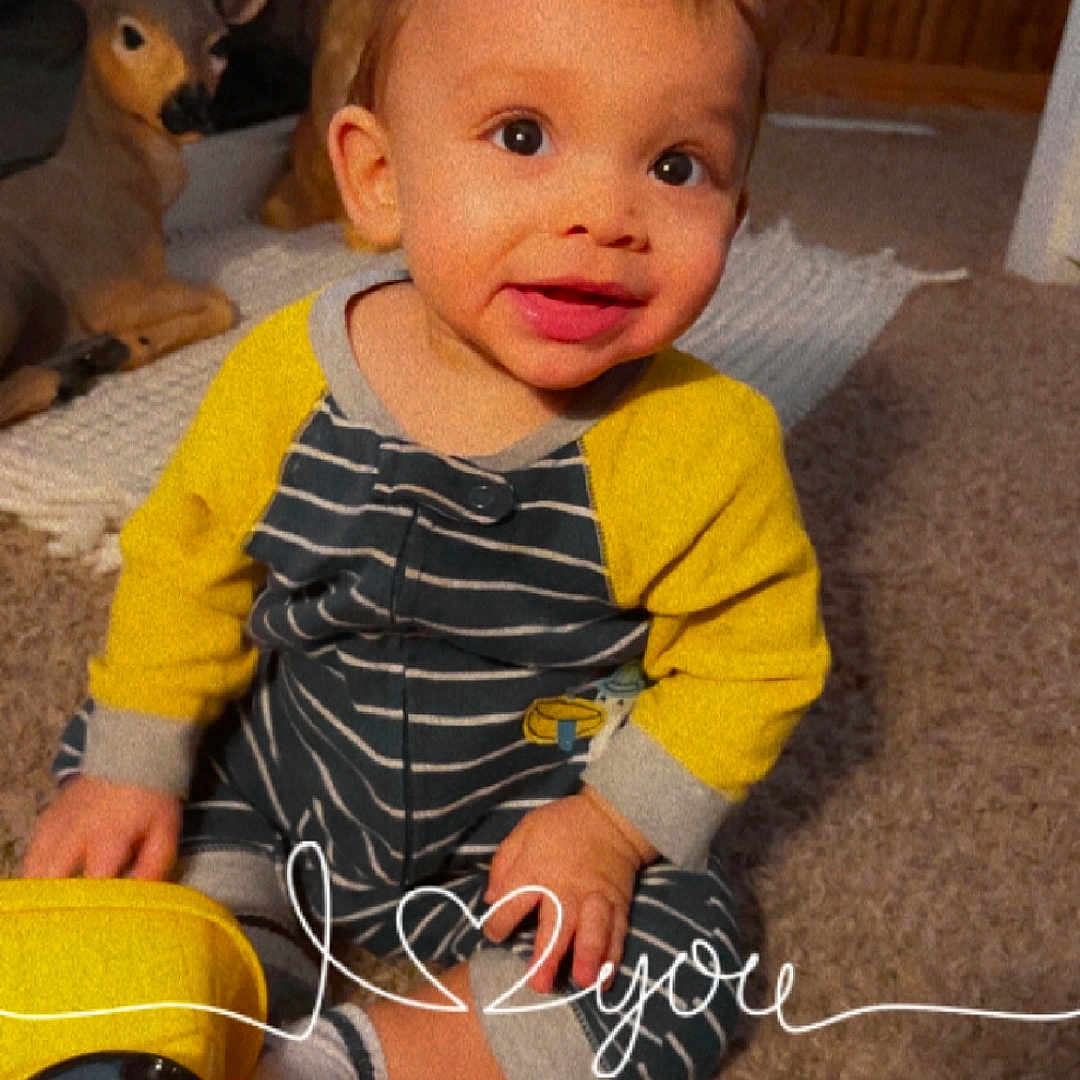 Jayce joined the competition — help win amazing prizes! baby, bodypart, clothing, couch, electronics, face, finger, footwear, furniture, hand, head, pants, person, phone, photography, portrait, shoe, shorts, toy, wood