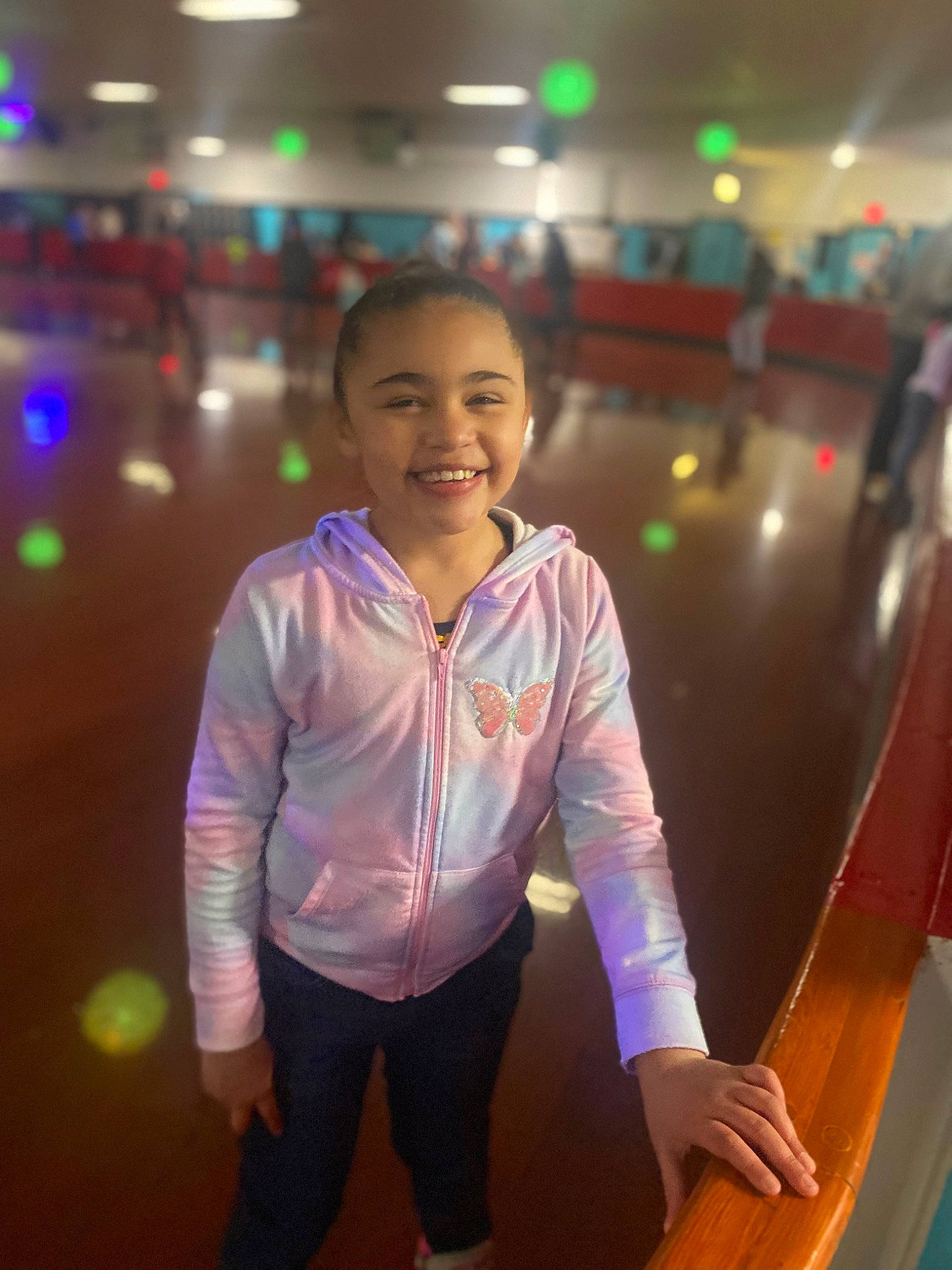 Arianna is registered to the contest to win money with this photo: child, entertainment, event, flash_photography, flooring, fun, games, happy, indoor_games_and_sports, joy, leisure, magenta, person, play, recreation, room, sitting, smile, standing, t_shirt
