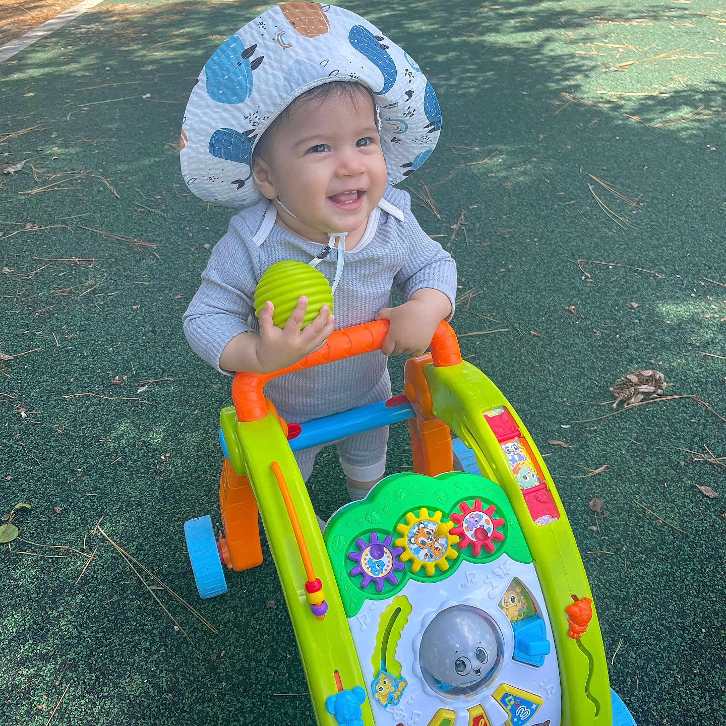 Henry joined the competition — help win amazing prizes! baby, bonnet, cap, clothing, dress, face, grass, hat, head, nature, outdoorplayarea, outdoors, park, person, photography, plant, playarea, portrait, soil, summer