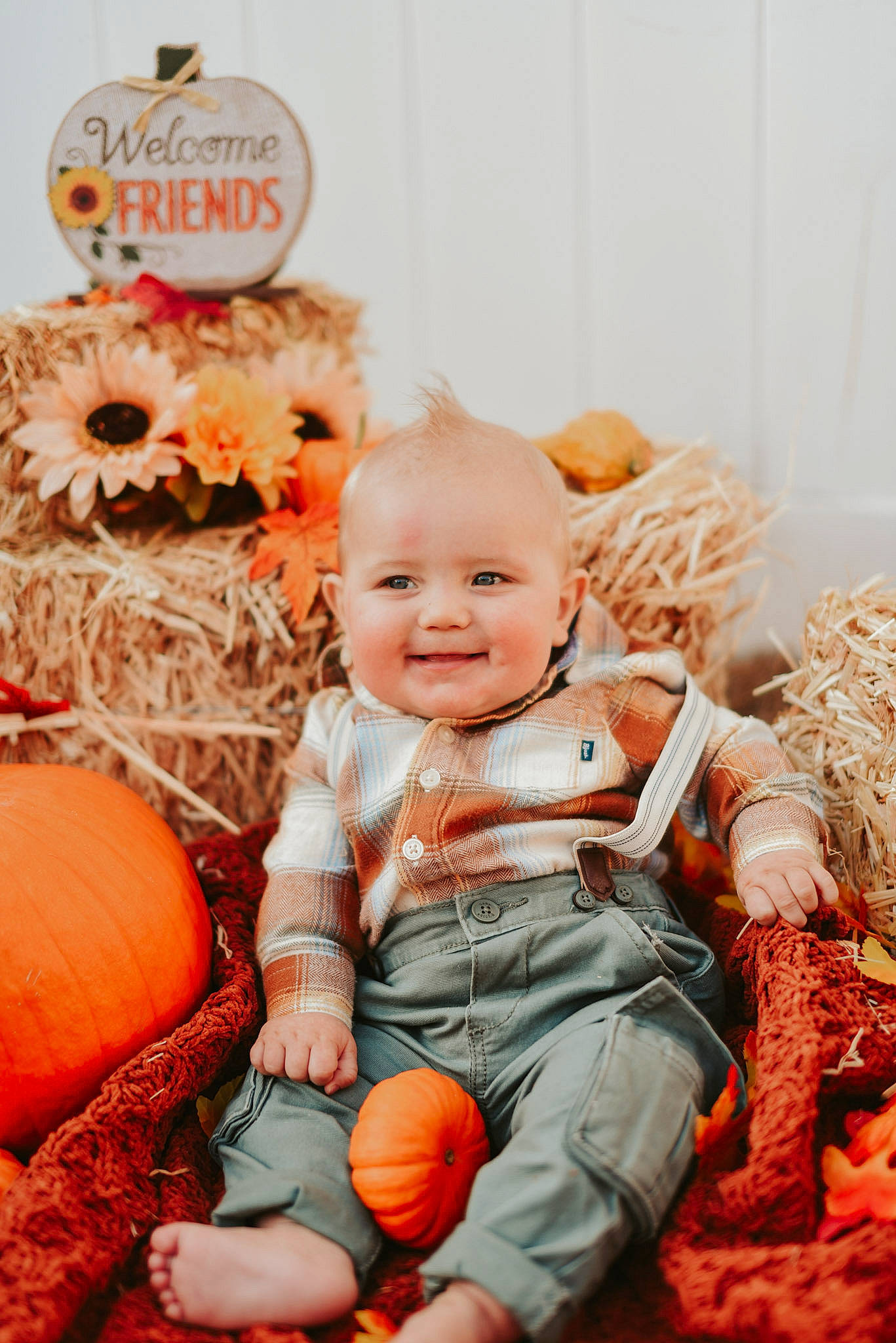 Kian is registered to the contest to win money with this photo: baby, baby_toddler_clothing, ball, beauty, calabaza, child, clothing, comfort, couch, facial_expression, happy, human, joy, orange, peach, people, person, pumpkin, sitting, smile