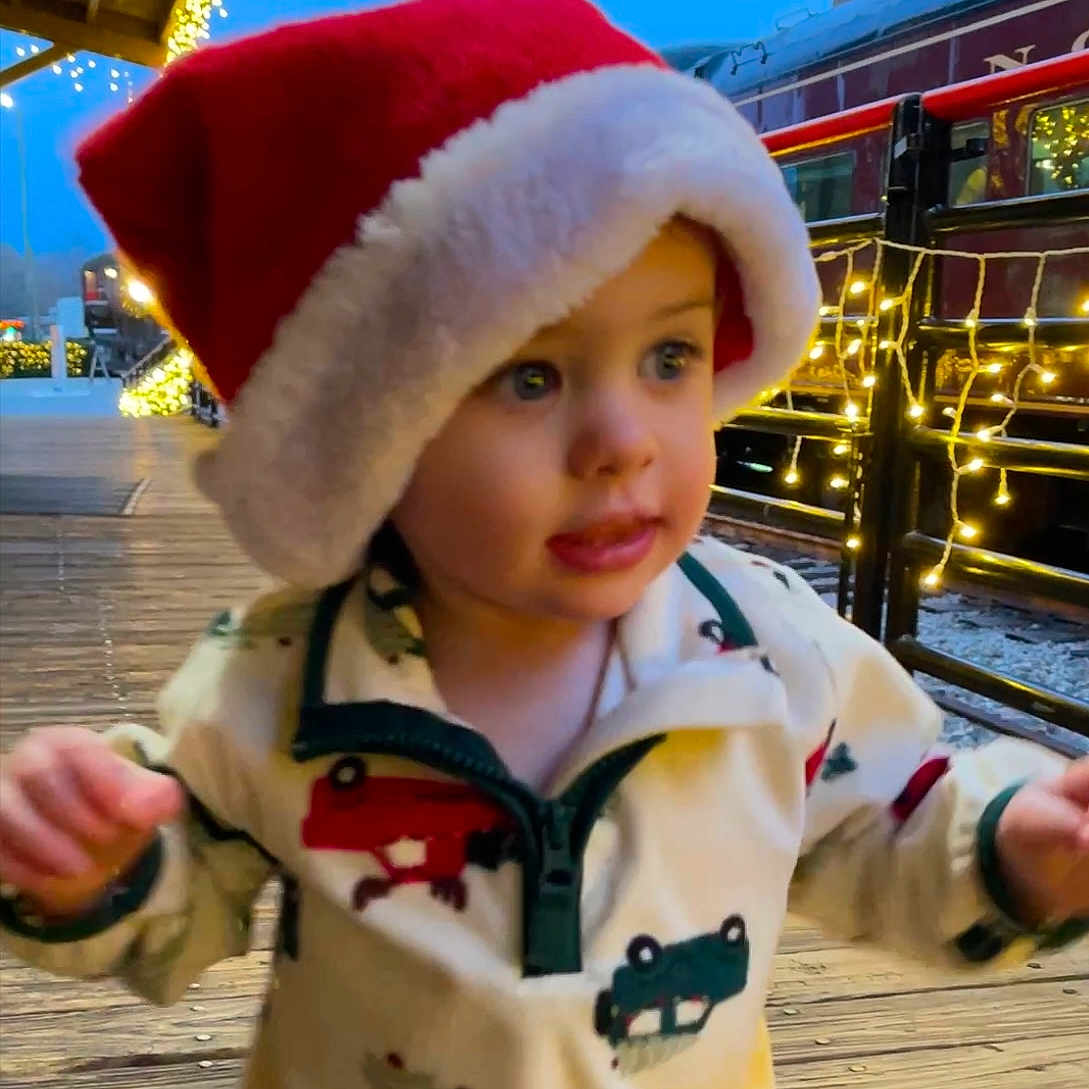 Elijah joined the competition — help win amazing prizes! baby, babylaughing, bodypart, bonnet, clothing, coat, face, festival, hand, happy, hat, head, hood, jacket, person, photography, portrait, smile, water, waterfront
