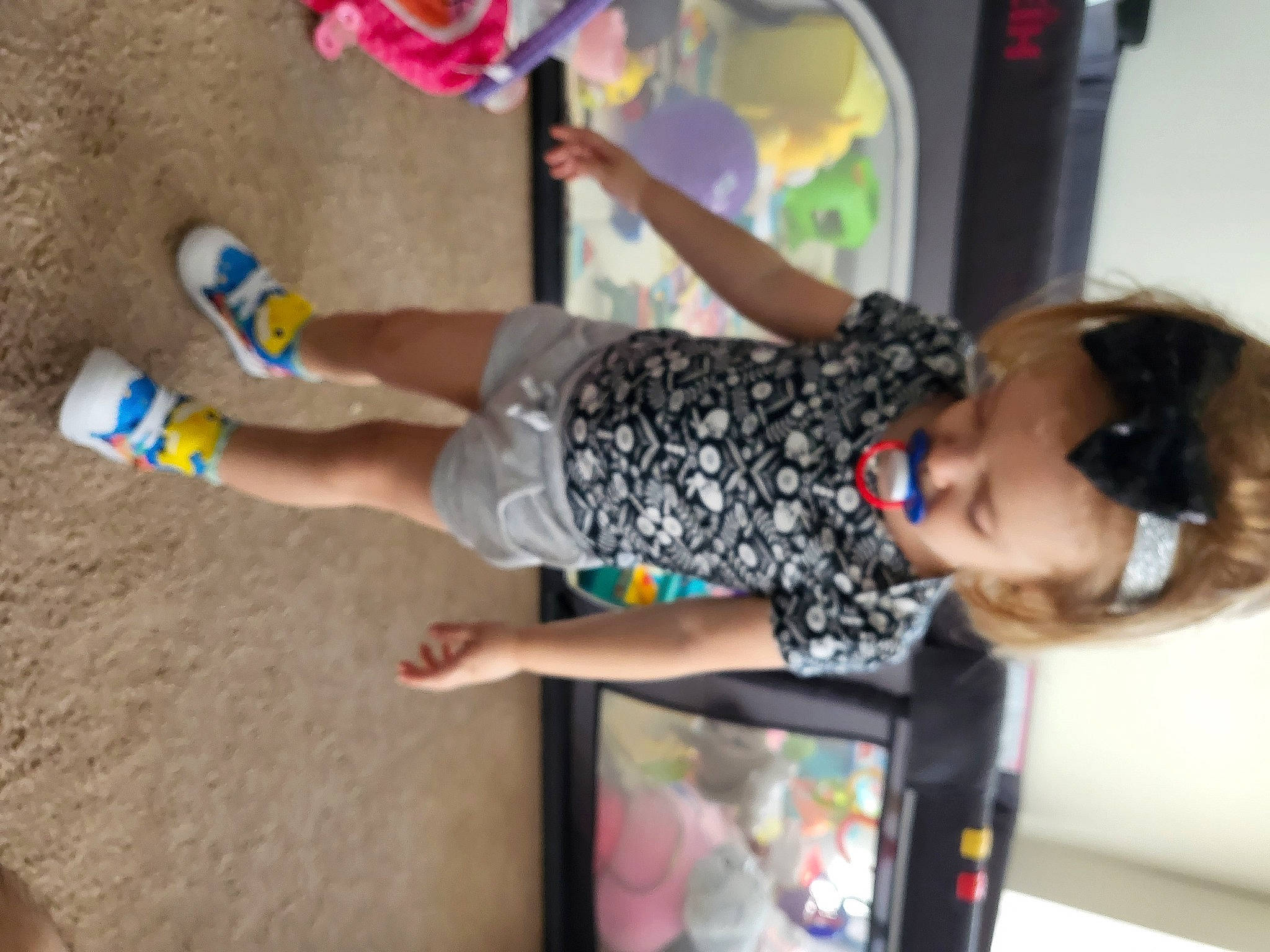 Sophi is registered to the contest to win money with this photo: calf, child, foot, fun, happy, human_leg, leisure, party, party_supply, person, play, recreation, sandal, shorts, sock, t_shirt, thigh, toddler, vacation, visual_arts