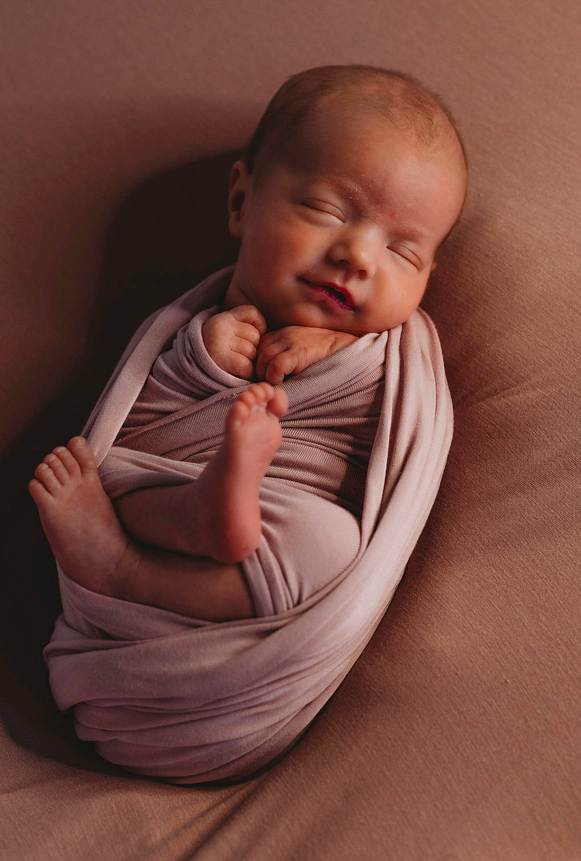 Kayden is registered to the contest to win money with this photo: baby, baby_toddler_clothing, cheek, comfort, elbow, flash_photography, flooring, gesture, happy, human_leg, linens, lip, neck, nose, person, sitting, sleeve, stomach, thumb, toddler