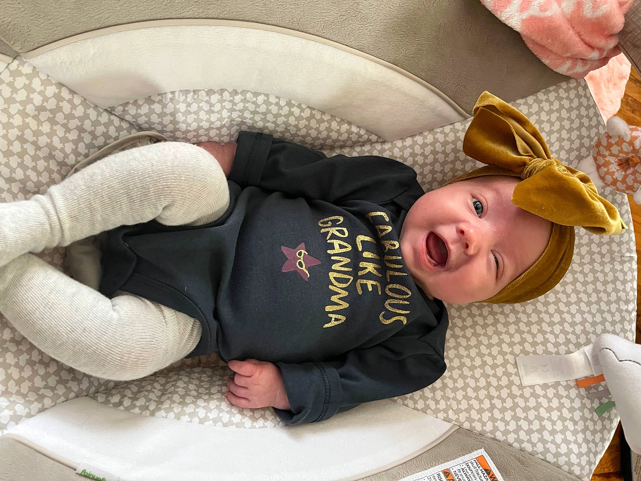 Kayden is registered to the contest to win money with this photo: baby, baby_products, baby_safety, baby_sleeping, baby_toddler_clothing, child, comfort, costume_hat, fashion_accessory, hat, headwear, linens, nap, person, room, sitting, sleeve, smile, sun_hat, toddler