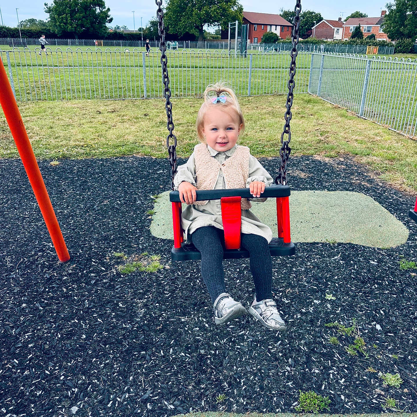 Denisa is registered to the contest to win money with this photo: casual, child, clothing, daylight, fence, fun, grass, happy, nature, outdoor, park, person, play, playground, shoes, smile, swing, toddler, tree, young_child