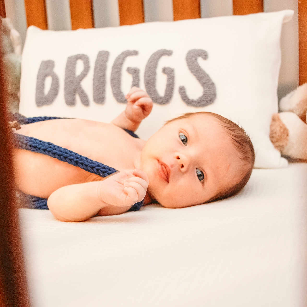 Briggs is registered to the contest to win money with this photo: baby, bed, blanket, bodypart, crib, cushion, face, finger, furniture, hand, head, homedecor, indoors, infantbed, newborn, person, photography, pillow, portrait