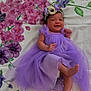 accessories, baby, bodypart, clothing, dress, face, finger, flower, flowerarrangement, flowerbouquet, formalwear, hand, head, jewelry, newborn, person, photography, plant, portrait, purple