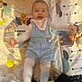 baby, bright, child, colorful, cute, denim_overalls, happy, indoor, infant, lying_down, patterned_mat, person, pink_bib, playmat, playtime, smiling, soft_toys, toddler, toy_ball, white_tights
