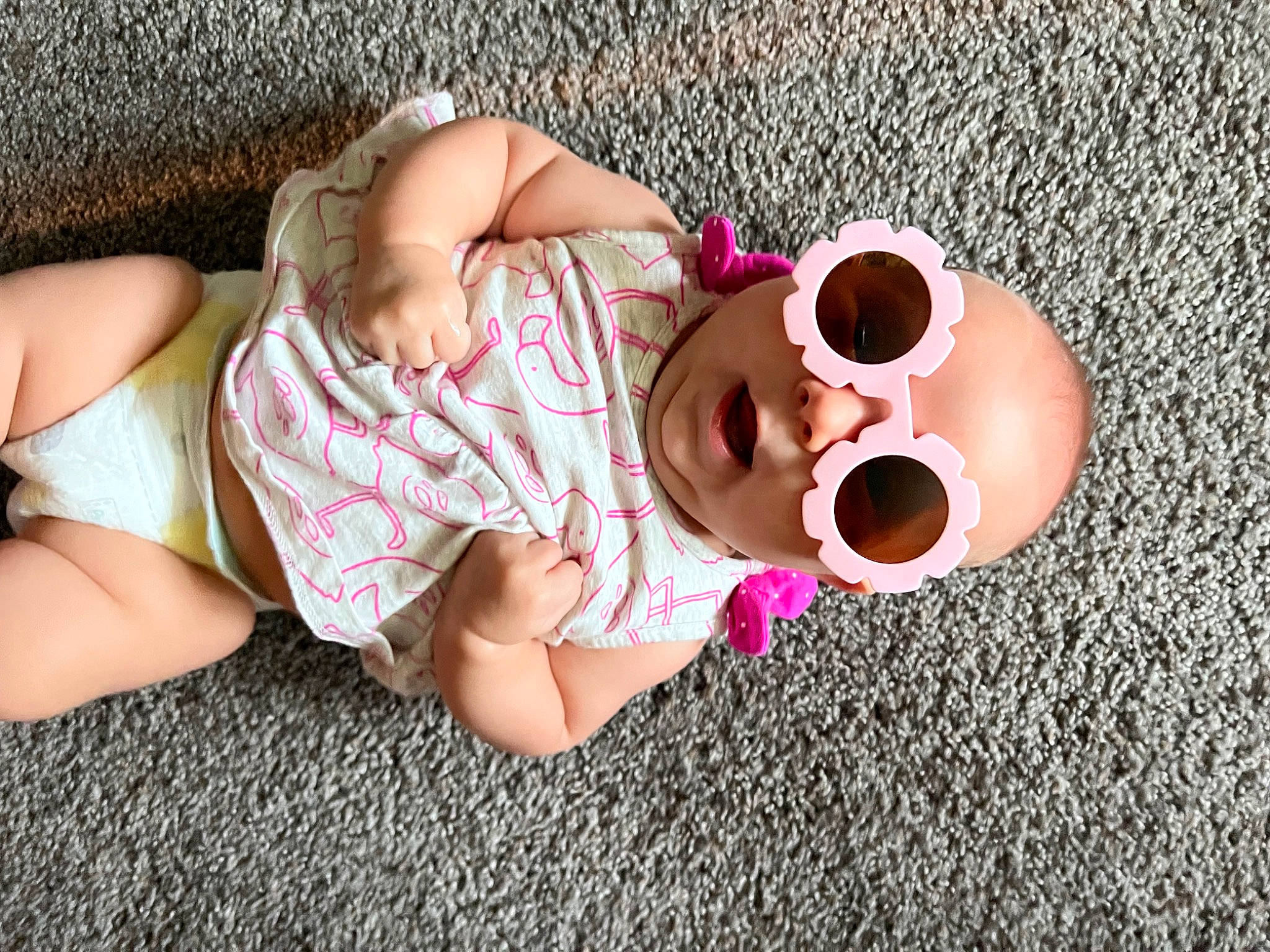 Willow is registered to the contest to win money with this photo: baby, baby_toddler_clothing, child, comfort, cool, eyewear, finger, foot, fun, glasses, goggles, grass, happy, leisure, person, pink, skin, sunglasses, thigh, toddler
